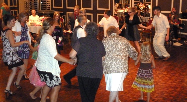 Photo of Band member teaching and leading a dance at a private party. Copyright 2010, Modal Music, Inc. (tm). All rights reserved.